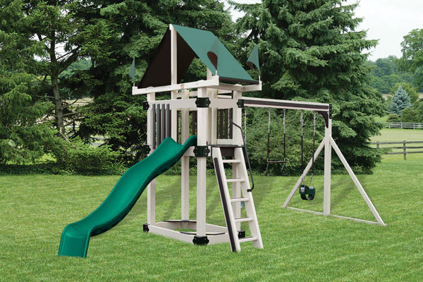 Children's playset with green slide and white frame in a grassy area