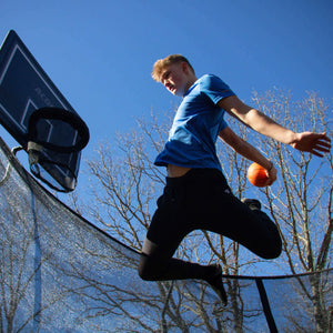 Person playing basketball on a trampoline