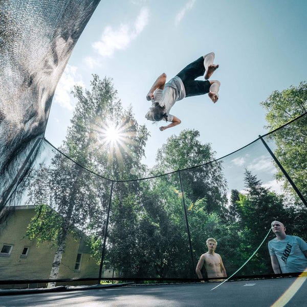 Person performing a jump on a trampoline