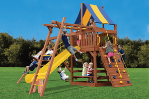 Kids climbing, sliding and swinging on a wooden playset with a striped canopy, rock wall and yellow slide