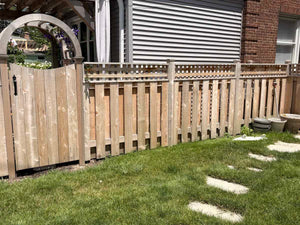 Arched cedar gate beside a board-on-board wood fence with a square lattice top in a North Shore backyard