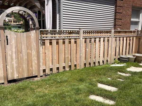 Arched cedar gate beside a board-on-board wood fence with a square lattice top in a North Shore backyard