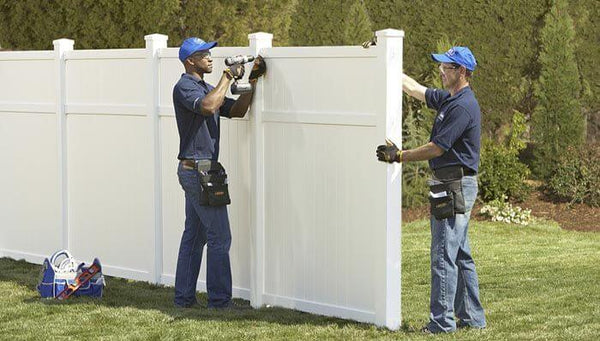 men-installating-white-fence
