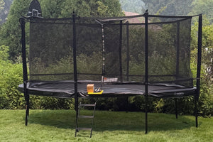 NORTH Legend oval above-ground trampoline with a full safety net and ladder in a Winnetka, IL backyard