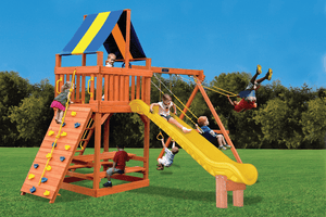 Wooden backyard playset with a yellow wave slide, rock-climbing wall, striped canopy and swings, with children playing on it