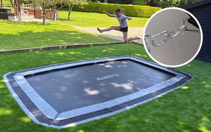 Child jumping on a trampoline with a close-up of a chain in the corner.