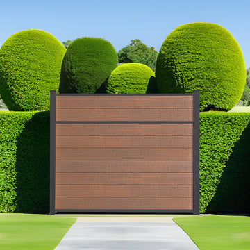 Dark brown horizontal slat composite fence panel between two manicured topiary shrubs