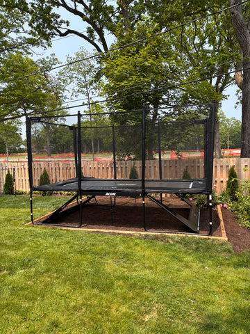 ACON rectangular in-ground trampoline being installed in a residential backyard