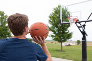 Boy shooting a basketball on the Proforce Basketball Hoop