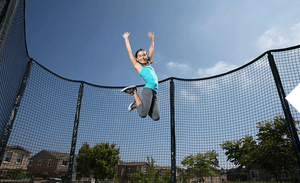 GIrl jumping on trampoline Fenceworks