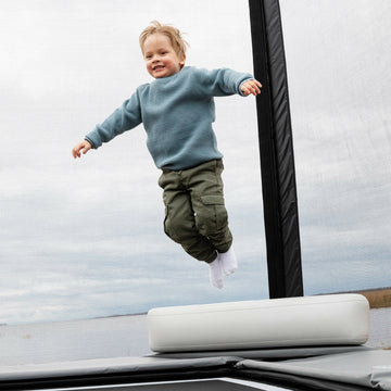 Child jumping on a trampoline 